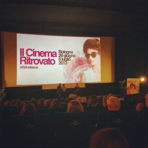 Waiting for a screening to begin at Cinema Arlecchino in Bologna.